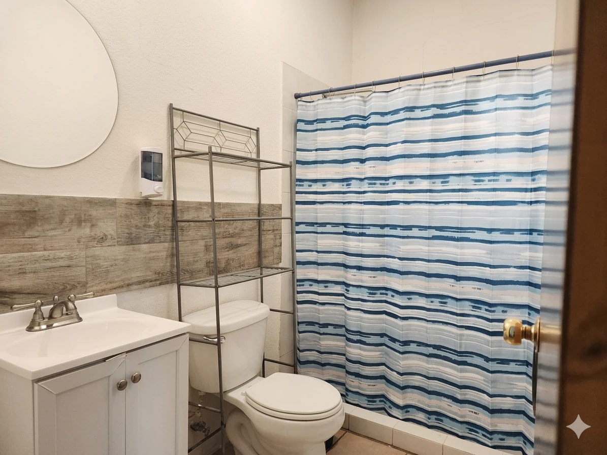 Baño privado con lavabo, regadera y cortina en la habitación con 2 camas